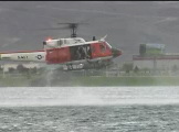 US Navy rescue chopper dropping swimmer. UH-1 Huey