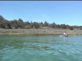 Small boat near shore with people fishing