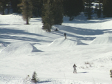 skiers and snowboarder on practice hills