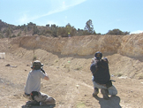 two men shooting guns at targets