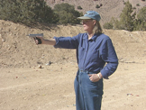 woman learning to shoot pistol