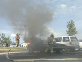 Fire Fighters putting out car fire