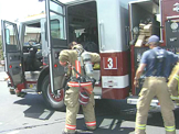 Fire Fighters taking off equipment