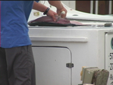 Man cleaning fish at dock