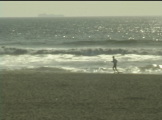 man running on  San Francisco beach