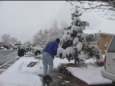 person shoveling sidewalk